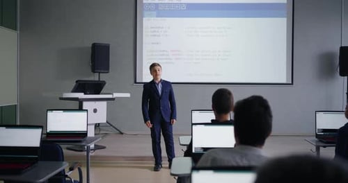 Genius Teen Boy Presenting His Project In Programming Classroom Classmates Looking At Display