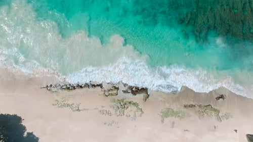 Turquoise Waves Hitting Sandy Shore with Rocks Seychelles Mahe