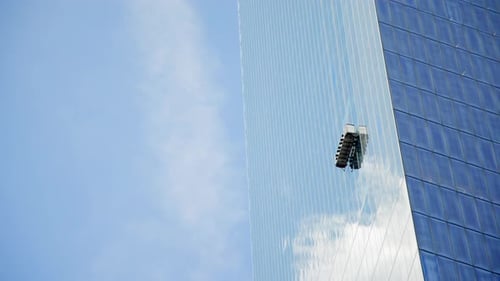 Window Cleaning Platform on Skyscraper Blue Sky Background