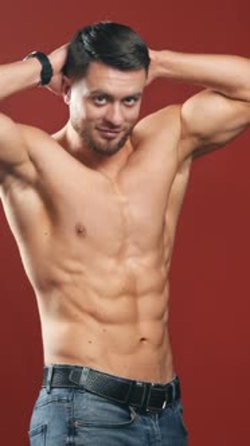 Muscular Man Posing Shirtless with Arms Behind Head
