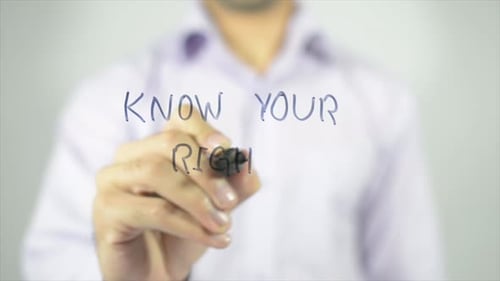 Writing Know Your Rights with Pen on Clear Surface