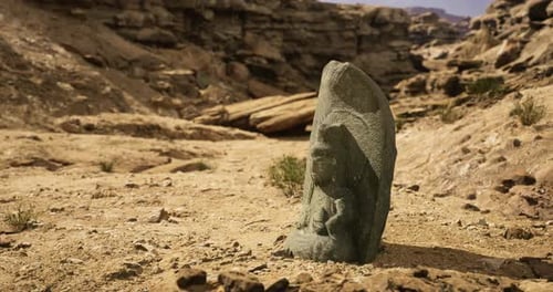Ancient Stone Carving of a Deity Found in Arid Landscape