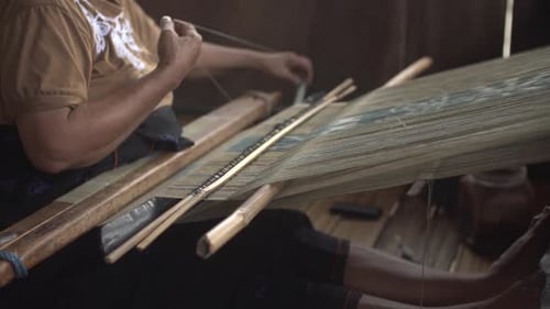 Indonesian women are using weaving loom