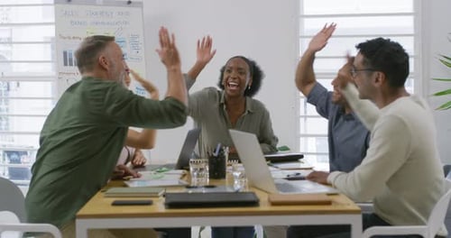 Business Team Celebrating Success in Modern Office