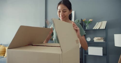 Woman Opens a Package at Home