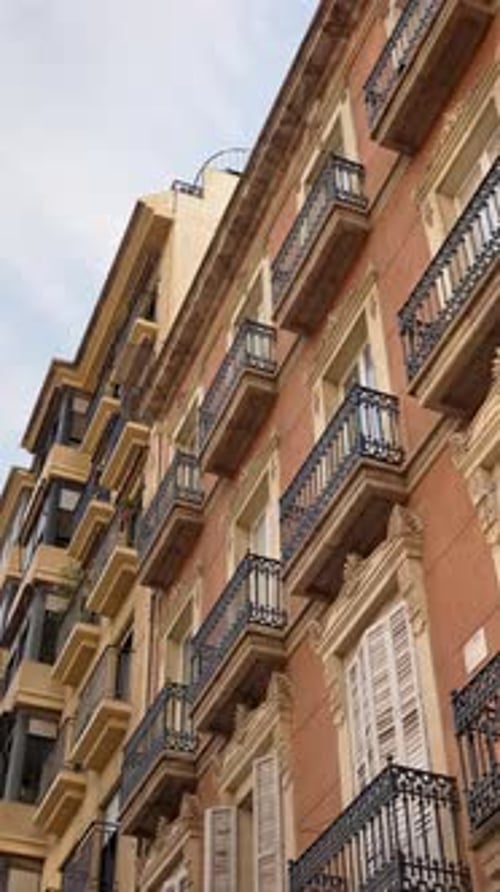 Low angle view of traditional residential buildings in Alicante, Spain, featuring ornate facades, wr