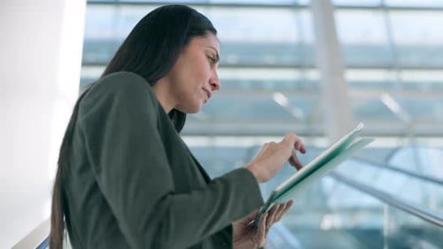 Young Adult Woman Uses Tablet in Modern Office