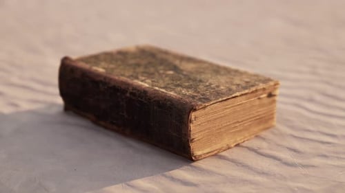 Old Book on the Sand Beach