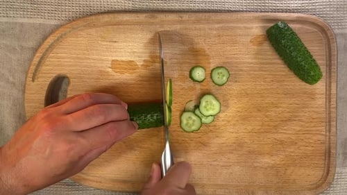 Pov Process of Slicing Green Fresh Cucumber on Wooden Kitchen Board at Home