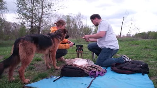 Couple Camping in Rural Nature with Dog