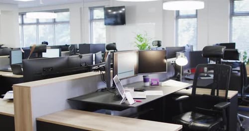 General view of empty modern office with multiple computers, slow motion