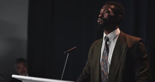 Professional Man Giving Speech at Podium