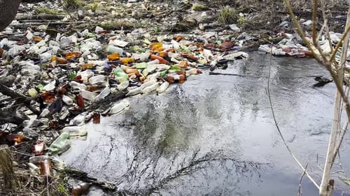 Dirty River is Polluted with Many Plastic Bottles A Lot of Trash is Dumped in Open and Freely