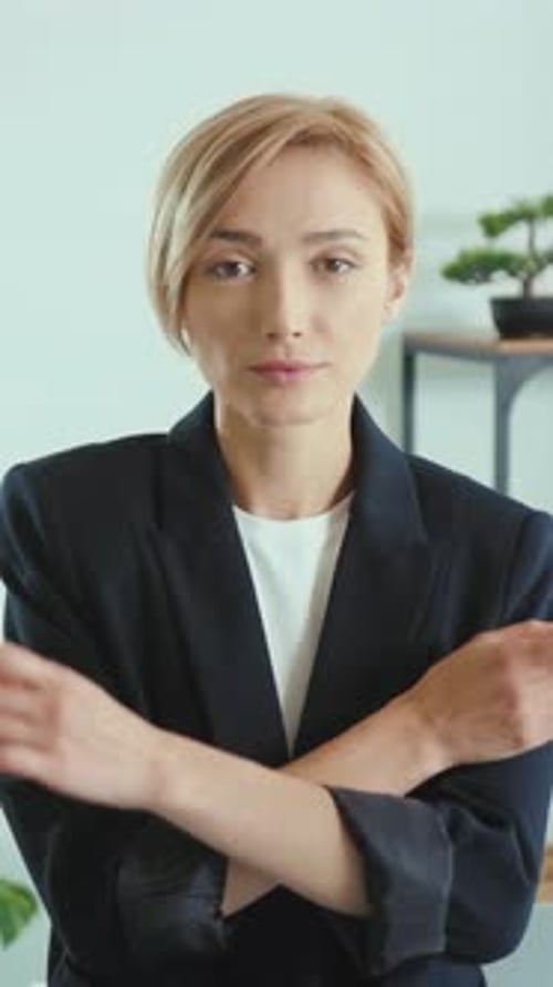 Confident Woman in Blazer Arms Crossed