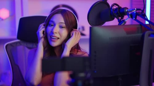 Asian young audio DJ woman sing a song on microphone to broadcasting.