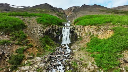Mountain River Flows Down A Sheer Cliff Many Waterfalls Surrounded By Green Bushes And Moss Stormy
