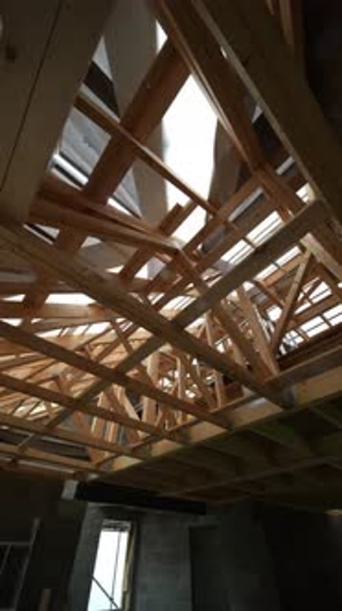 Interior view of unfinished home construction with roof