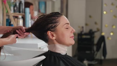 Woman Having Her Hair Washed in Salon Spa