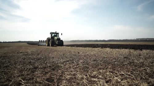 Tractors plowing the field in Ukraine