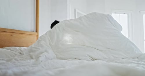 Man Wakes Up in a Bright Bedroom
