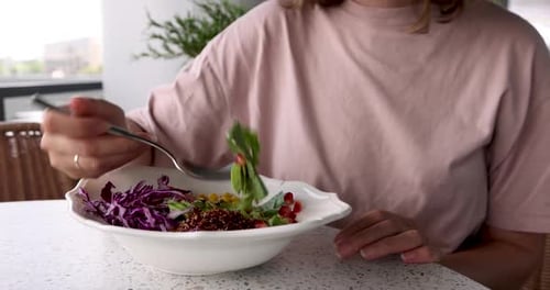Woman Eating Quinoa Salad at Outdoor Cafe