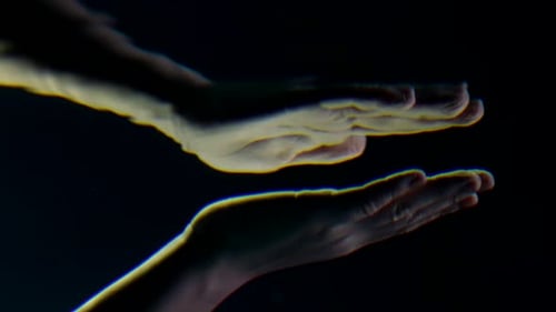 Hands Reflected Against Black Background