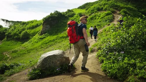 Excursion In Natural Landmarks Group Of Tourists And Travelers Walking In Beautiful Mountains