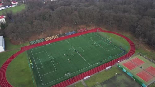 Aerial View of Stadium in Small Town Players Play Football on Soccer Field