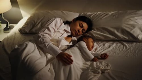 Mother and Infant Sleeping Peacefully in Bed