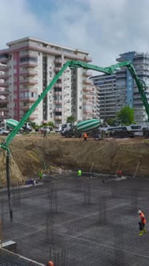 Vertical Video Engineers Oversee Skilled Workers Bending Rebar and Pouring Concrete on a HighQuality