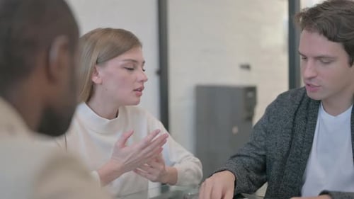 Close up of Young Woman Talking with Teammates