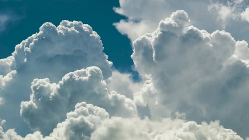 Clouds Moving Slowly Across the Bright Blue Sky