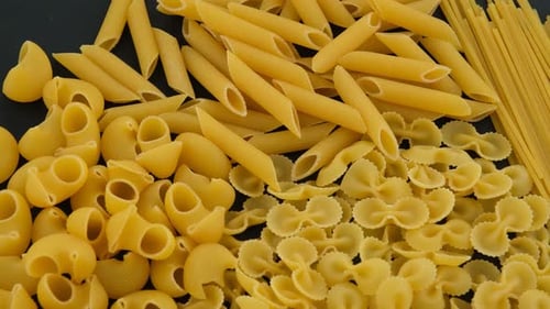Variety of Dried Pasta on a Dark Background