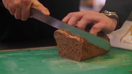 Slicing a Loaf of Dark Seeded Bread