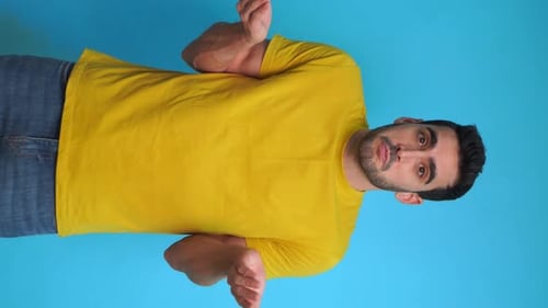 Man Poses and Gestures Against a Blue Background