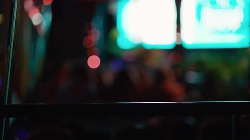 A Blurry Nighttime Scene with Colorful Lights and a Defocused Audience Capturing a Lively Events