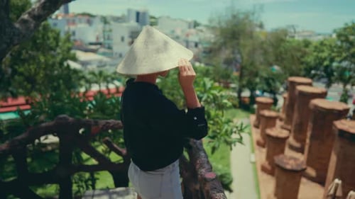 Woman in Traditional Asian Conical Hat Standing Alone in Beautiful Park in City Walk in Oriental