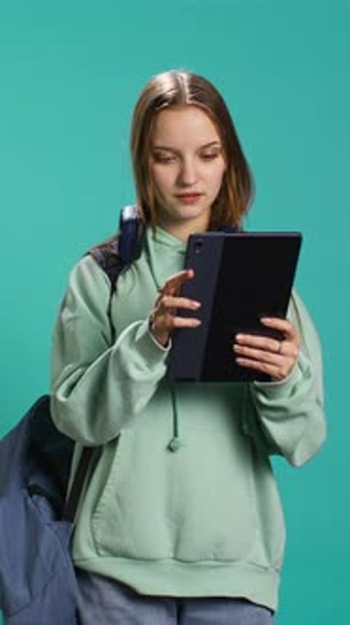 Vertical Video Woman Scrolling on Tablet Touchscreen Checking Social Media Feed