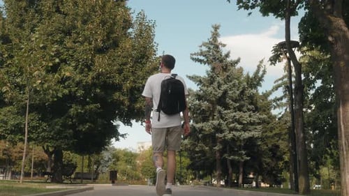 Man Walking Through Park
