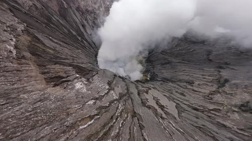 FPV Drone Dive Into Steaming Bromo Volcanic Crater in East Java Indonesia