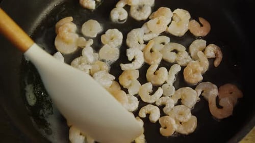 A Closeup of the Process of Frying Sea Shrimp in Oil Top View