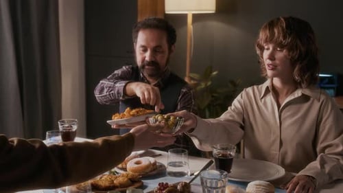 Family Celebrates Hanukkah with Meal and Menorah