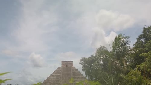 Gimbal wide booming down shot of the ancient Mayan pyramid El Castillo at Chichen Itza in Yucatan, M