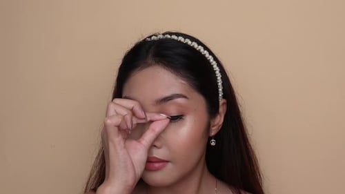 Woman Applying False Eyelashes for Beauty Routine