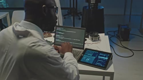 Tech Developers Working with Human Like Robot in Dark Lab