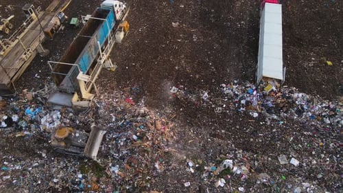 Overhead View of Garbage Dump with Trucks and Heavy at Work