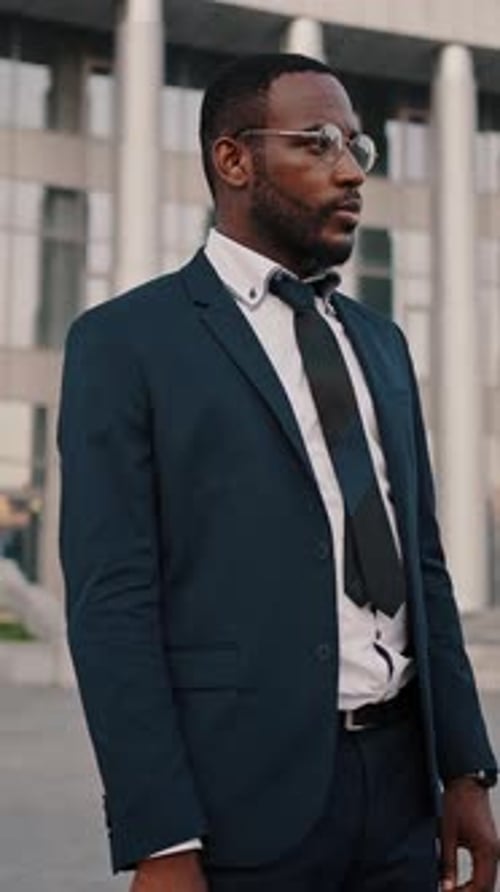 Man in Suit Holding Briefcase Outside Building