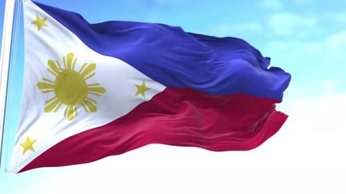 Waving Flag of the Philippines Against Blue Sky