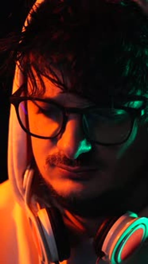 Close Up of Man with Headphones in Dark Room