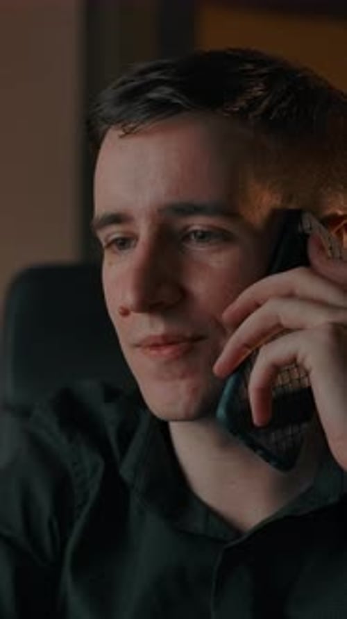 Young Adult Talking on Cell Phone Indoors